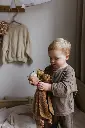 child with teddies.webp